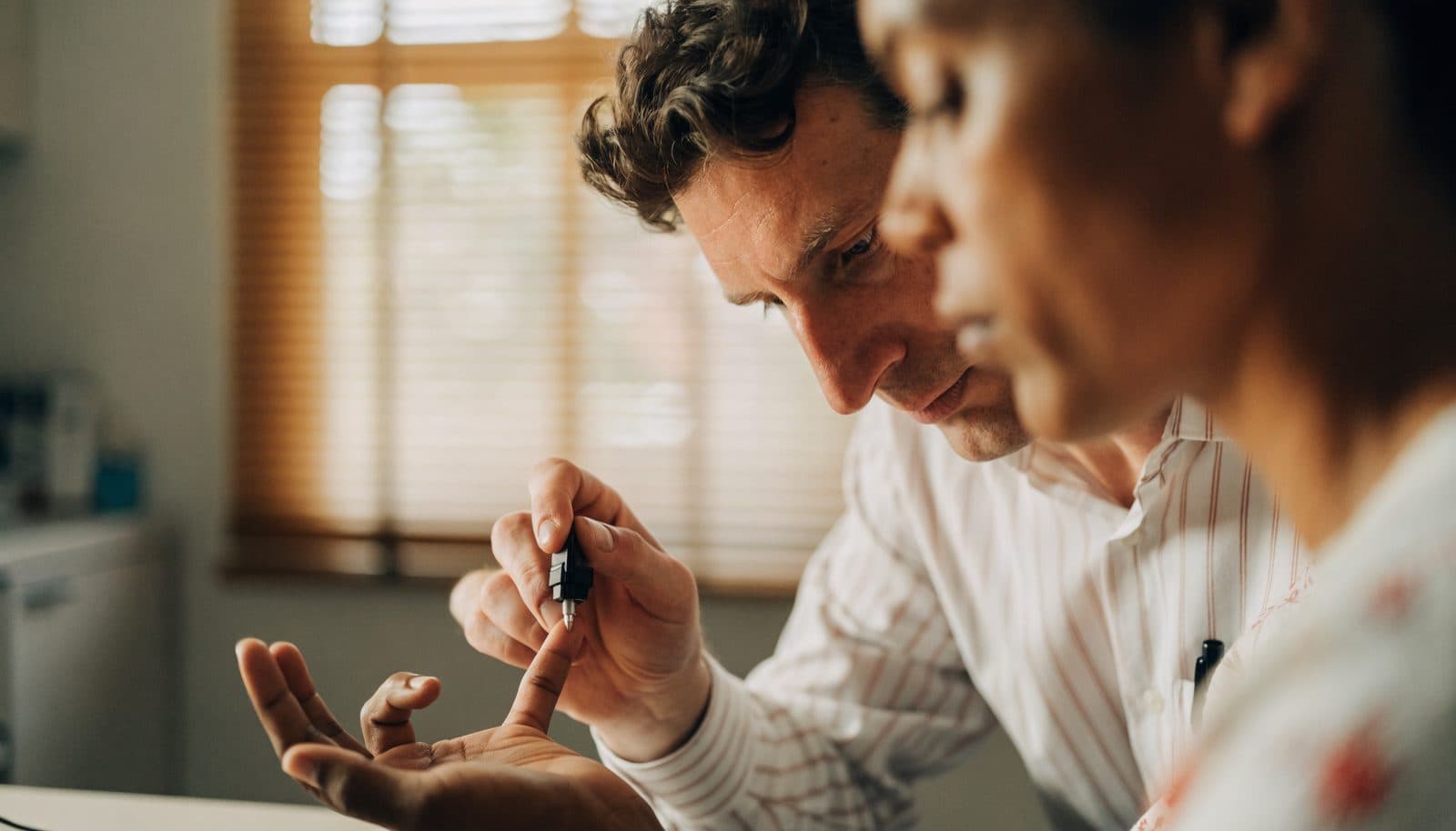 A physician performing a quick noninvasive screening test during an office visit