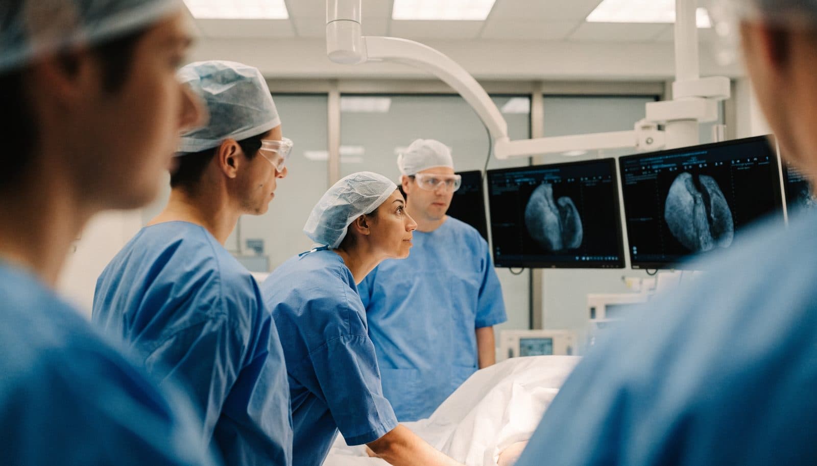 A structural heart team reviewing imaging after a transcatheter valve procedure